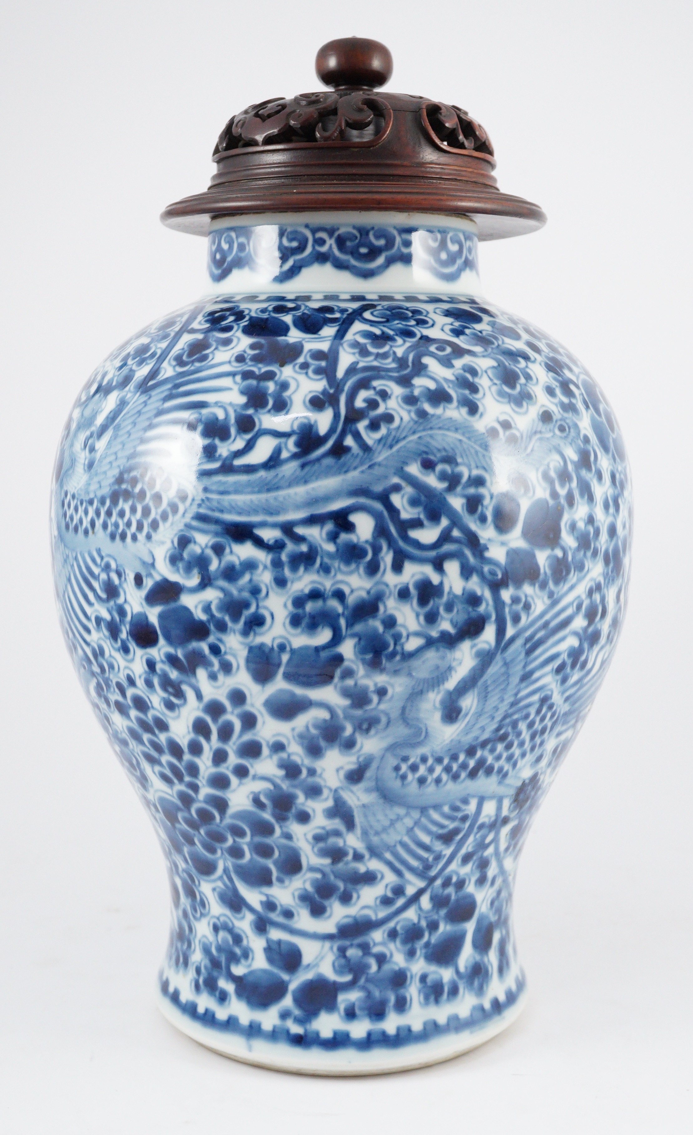 A Chinese blue and white ‘phoenix and peony’ baluster jar, Kangxi period, with a later wood cover, 36cm high excluding later wood cover